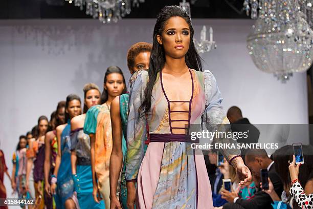 Model displays a creation by Haitian Michel Chataigne during the Dominicana Moda Fashion Week in Santo Domingo on October 19, 2016. / AFP / afp /...