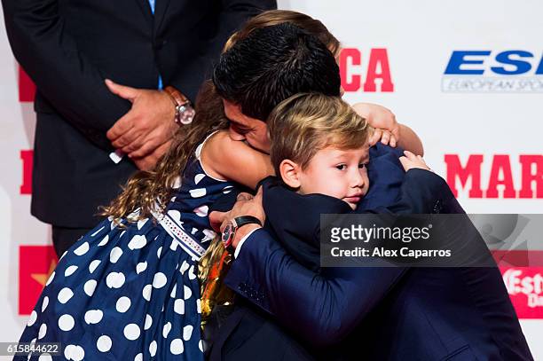 Luis Suarez of FC Barcelona embraces his daughter Delfina and his son Benjamin as they present to him the Golden Boot Trophy as the best goal scorer...