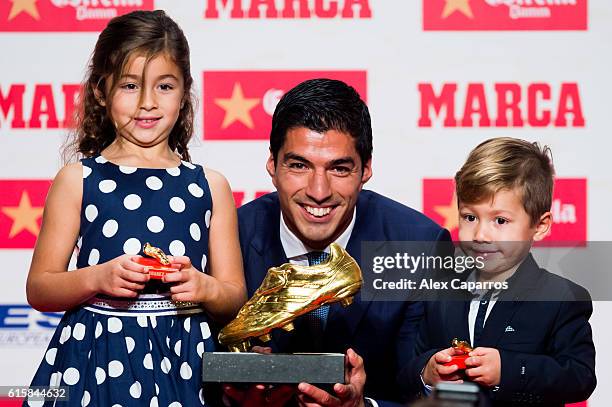 Luis Suarez of FC Barcelona poses with his daughter Delfina and his son Benjamin with the Golden Boot Trophy as the best goal scorer in all European...