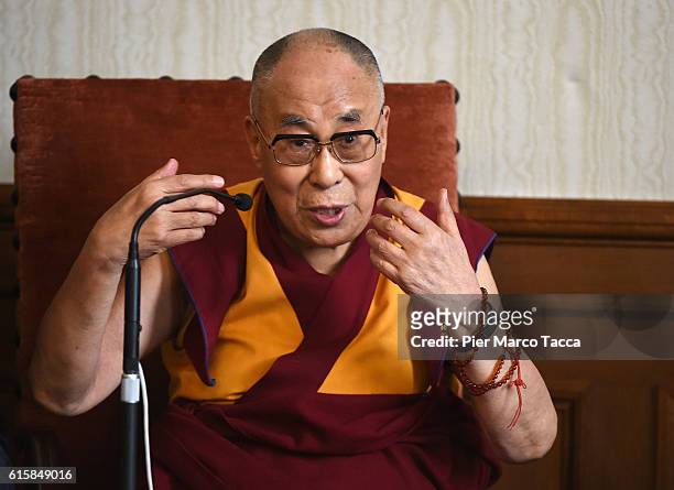 Dalai Lama gestures during a meeting with the Milan Archibishop Angelo Scola on October 20, 2016 in Milan, Italy. The Dalai Lama spiritual leader of...