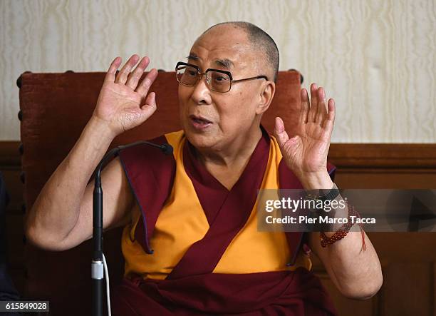 Dalai Lama gestures during a meeting with the Milan Archibishop Angelo Scola on October 20, 2016 in Milan, Italy. The Dalai Lama spiritual leader of...