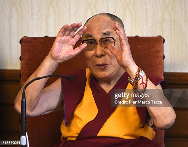 Dalai Lama gestures during a meeting with the Milan Archibishop Angelo Scola on October 20, 2016 in Milan, Italy. The Dalai Lama spiritual leader of...