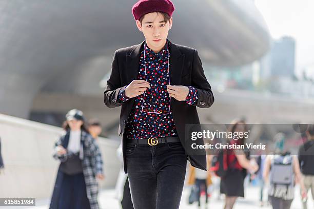 Korean model Kim KiBum wearing a beret, shirt with star print, Gucci belt on October 20, 2016 in Seoul, South Korea.