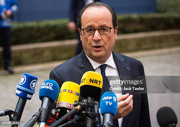 French President Francois Hollande addresses assembled media as he arrives at the Council of the European Union on the first day of a two day summit...