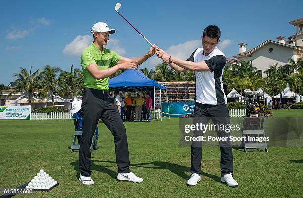 Li Haotong of China gives a clinic to golfers including singer Pakho Chau on the sidelines of World Celebrity Pro-Am 2016 Mission Hills China Golf...