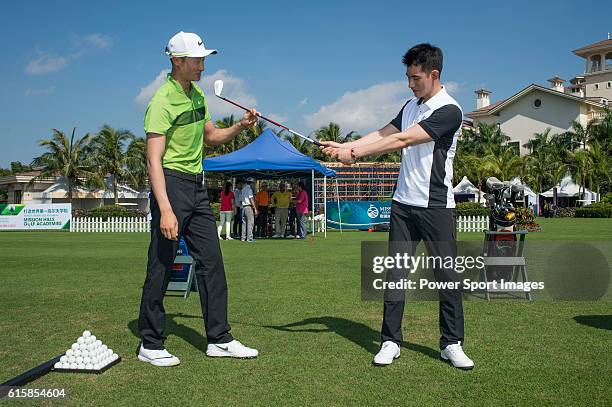 Li Haotong of China gives a clinic to golfers including singer Pakho Chau on the sidelines of World Celebrity Pro-Am 2016 Mission Hills China Golf...