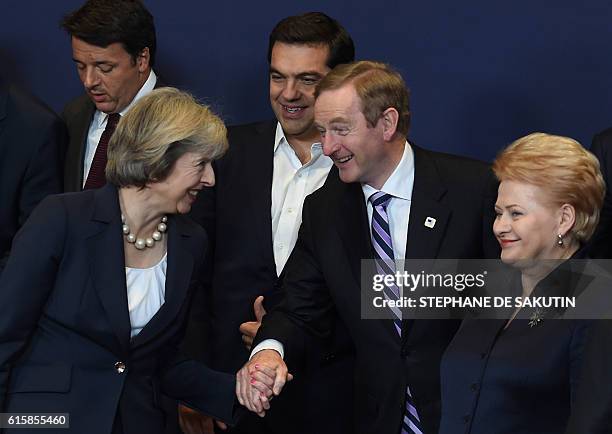 Britain's Prime minister Theresa May interacts with Ireland's Prime minister Enda Kenny , flanked by Italy's Prime minister Matteo Renzi , Greece's...