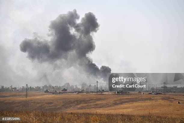 Smoke billows from a combined aircraft, artillery and ground attack to recapture the village of Tiskharab from ISIS on October 20, 2016 near Mosul,...