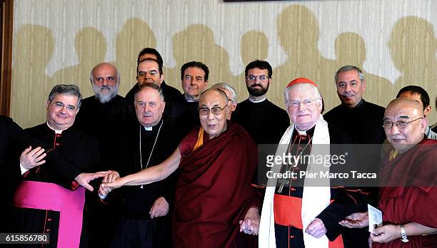 Dalai Lama, Milan Archibishop Angelo Scola and some people of the Delegation pose during a meeting with the archbishop on October 20, 2016 in Milan,...
