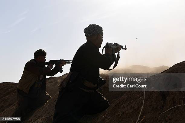 Kurdish peshmerga fighters fire at an ISIS position during an assault to recapture the village of Tiskharab on October 20, 2016 near Mosul, Iraq....