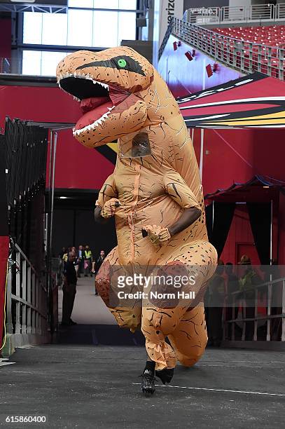 Patrick Peterson of the Arizona Cardinals runs onto the field wearing inflatable T-Rex costume prior to a game against the New York Jets at...