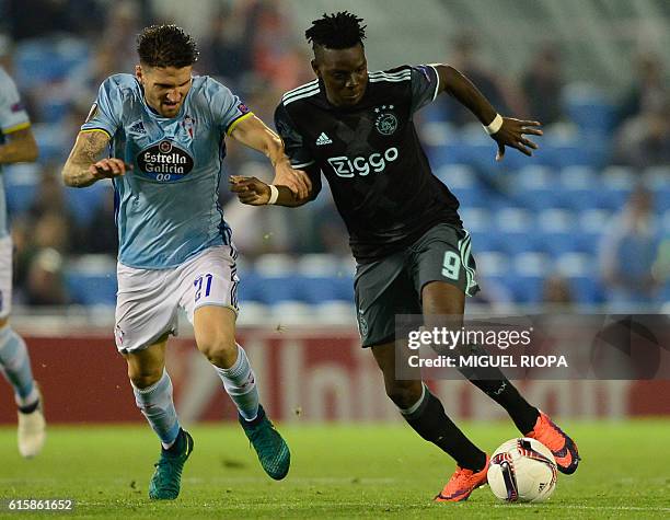 Celta Vigo's defender Carles Planas vies with Ajax's Burkinabe forward Bertrand Traore during the Europa League football match RC Celta de Vigo vs...