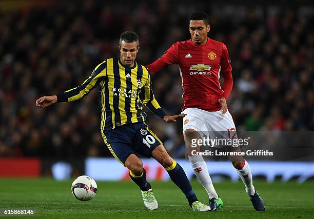 Robin van Persie of Fenerbahce is closed down by Chris Smalling of Manchester United during the UEFA Europa League Group A match between Manchester...