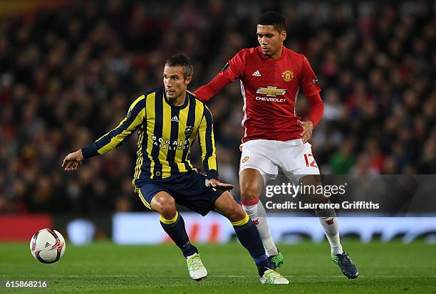 Robin van Persie of Fenerbahce is closed down by Chris Smalling of Manchester United during the UEFA Europa League Group A match between Manchester...