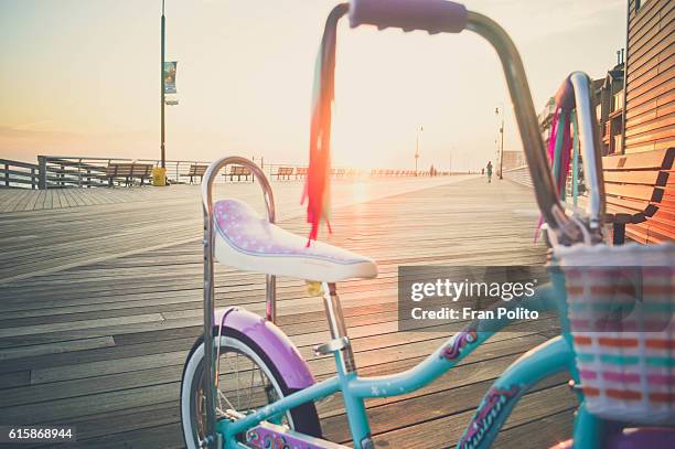 young girl's bike on the boardwalk at the beach. - training wheels stock pictures, royalty-free photos & images