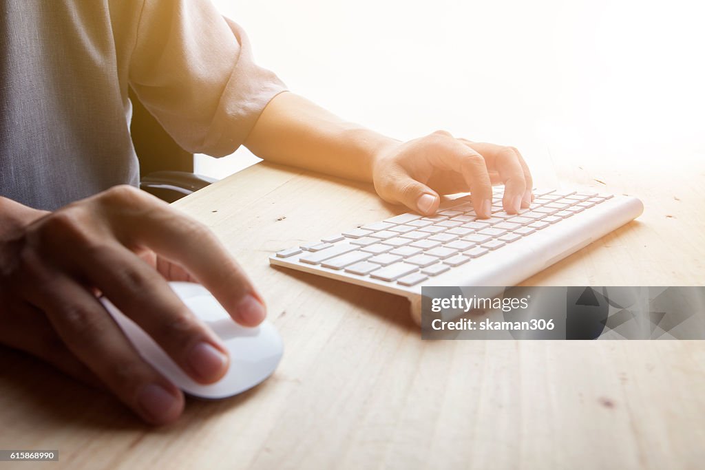 Man's Hand use mouse and typing keyboard
