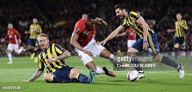 Fenerbahce's Turkish defender Sener Ozbayrakli fouls Manchester United's French striker Anthony Martial to concede Manchester United's second penalty...