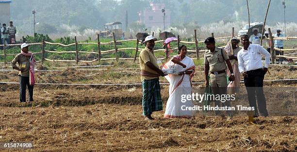 West Bengal Chief Minister Mamata Banerjee sowing mustard seeds in land which was earlier allotted for Nano Plant Singur on October 20, 2016 in...