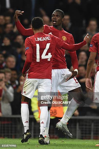 Manchester United's French midfielder Paul Pogba and Manchester United's English midfielder Jesse Lingard strike a pose at the end of a celebration...