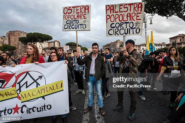 Demonstrators shout slogans and march with lit flares and flags as they take a rally to protest against the eviction of CSOA Corto Circuito Social...