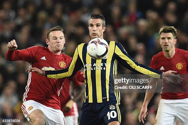 Fenerbahce's Dutch forward Robin van Persie controls the ball under pressure from Manchester United's English striker Wayne Rooney during the UEFA...