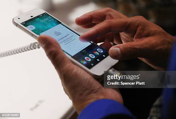 Person tries a new Google Pixel phone at the Google pop-up shop in the SoHo neighborhood on October 20, 2016 in New York City. The shop lets people...
