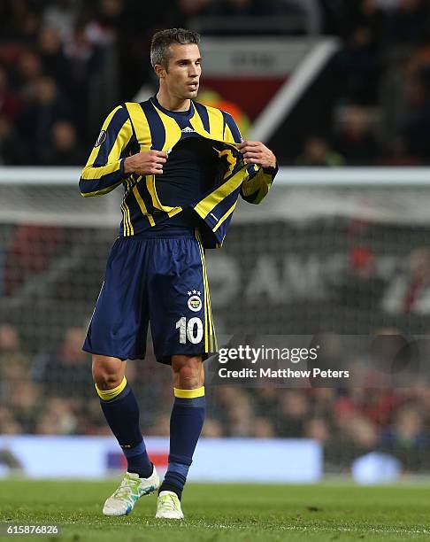 Robin van Persie of Fenerbahce has his shirt ripped during the UEFA Europa League match between Manchester United FC and Fenerbahce SK at Old...