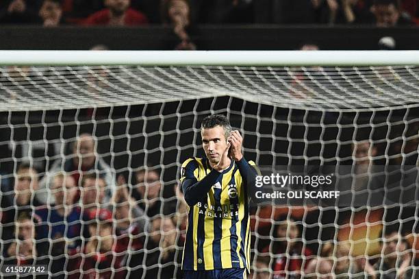 Fenerbahce's Dutch forward Robin van Persie applauds the crowd as he receives an ovation from them after scoring Fenerbahce's first goal during the...