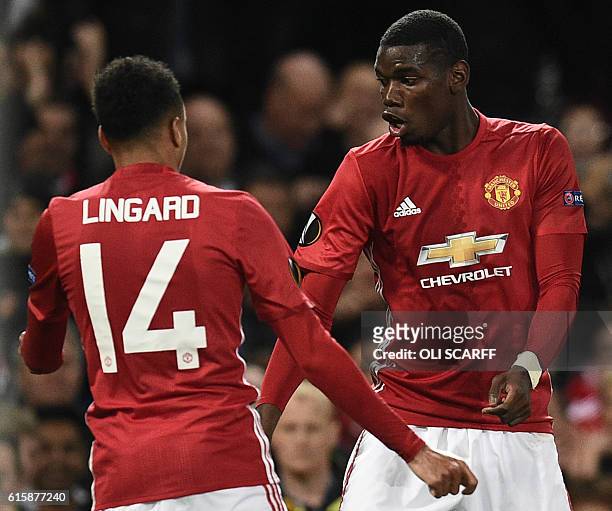 Manchester United's French midfielder Paul Pogba and Manchester United's English midfielder Jesse Lingard do a celebration dance after Pogba scored...