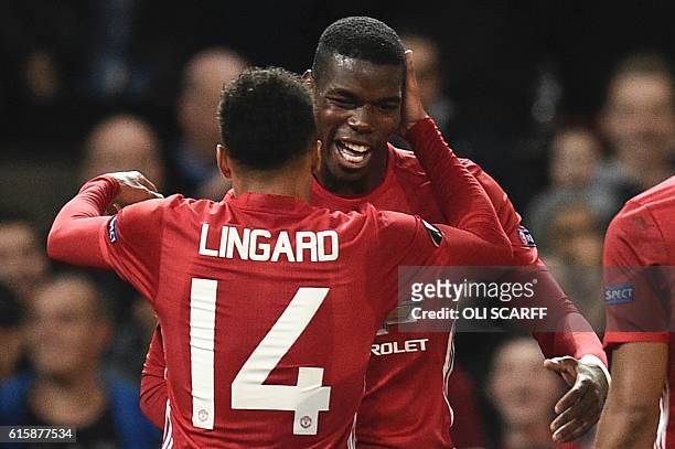 Manchester United's French midfielder Paul Pogba and Manchester United's English midfielder Jesse Lingard celebrate after Pogba scored their third...