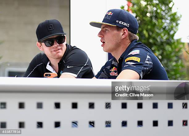 Max Verstappen of Netherlands and Red Bull Racing talks with IndyCar driver Conor Daly of United States during previews ahead of the United States...