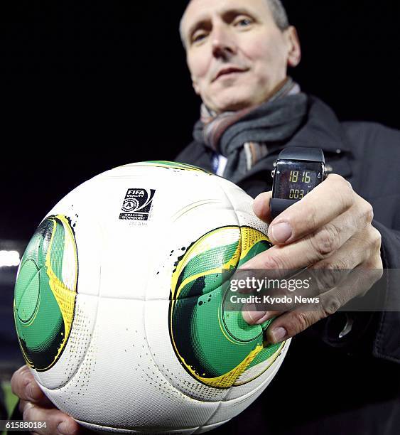 Japan - Photo taken at Nissan Stadium in Yokohama on Dec. 5 shows a ball with an embedded sensor and a watch for referees used in GoalREF goal-line...