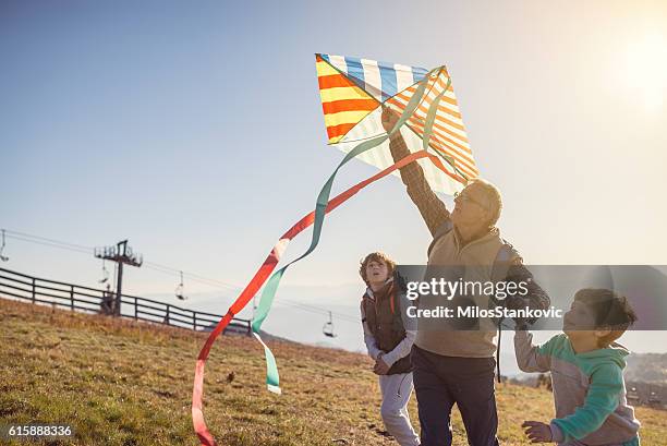 flying a kite with grandfather - kids hobbies stock pictures, royalty-free photos & images