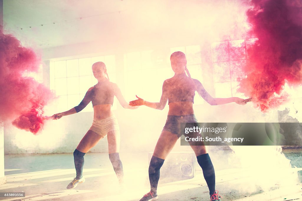 Two girls dancing in the smoke