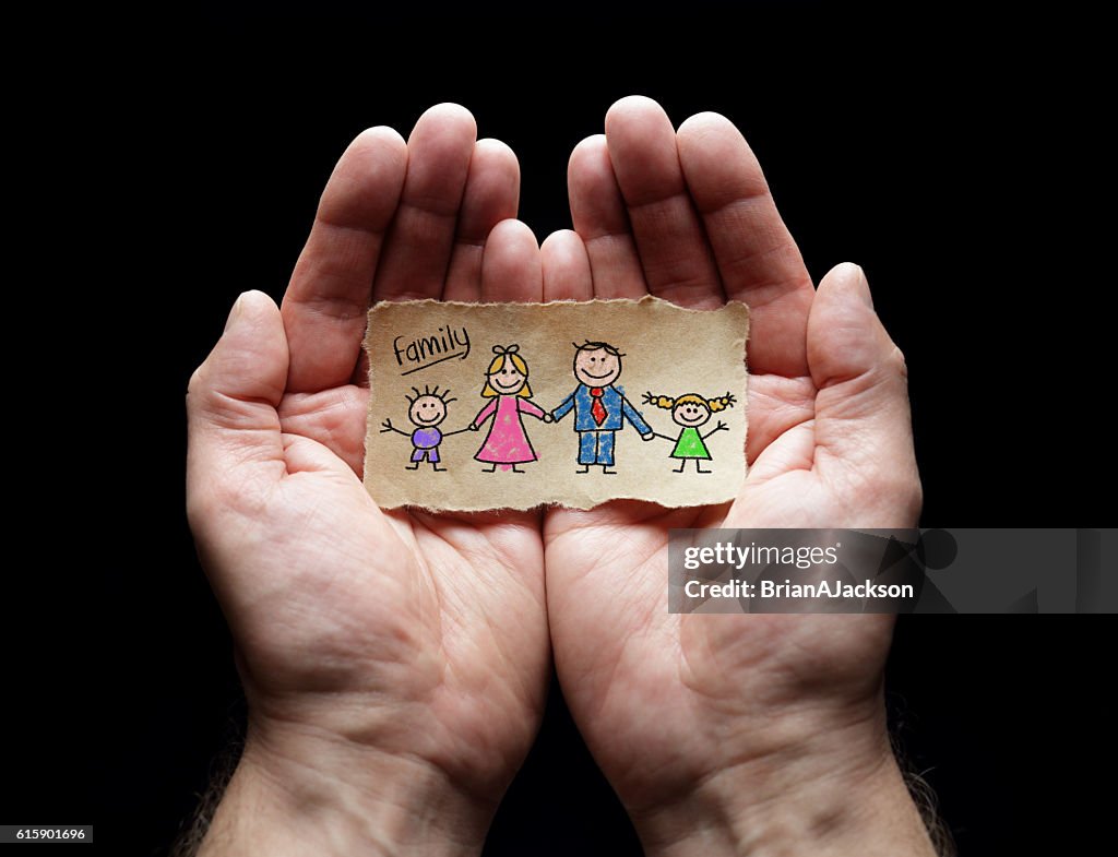 Child drawing of family with the protection of cupped hands