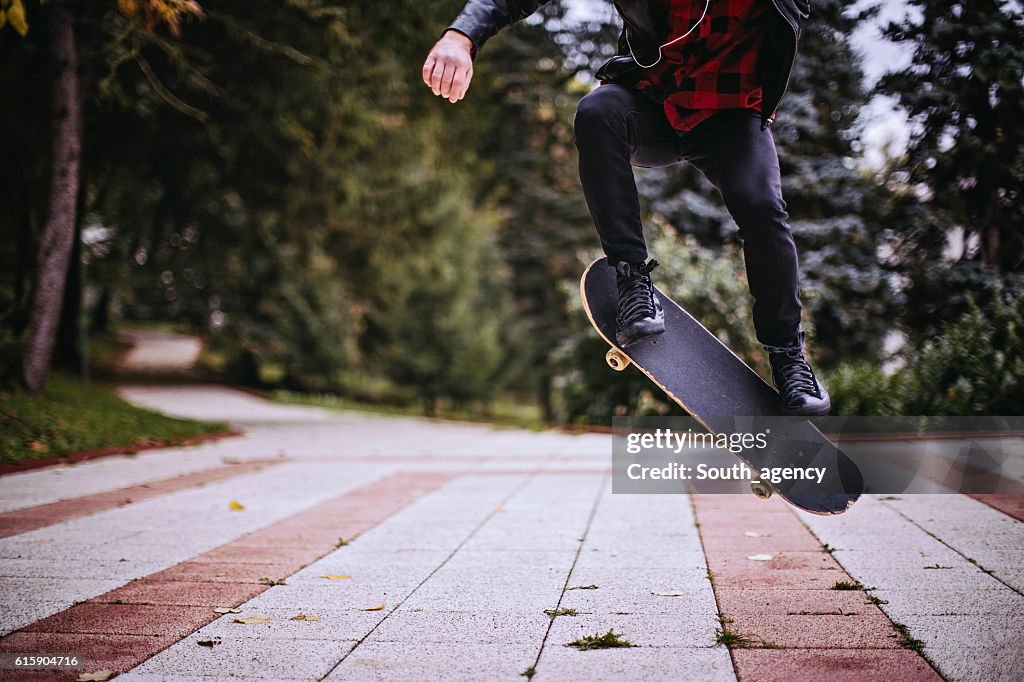 Hipster jumping with a skateboard