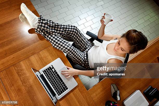 freelance gender fluidity young woman working in home studio. - pyjama stockfoto's en -beelden
