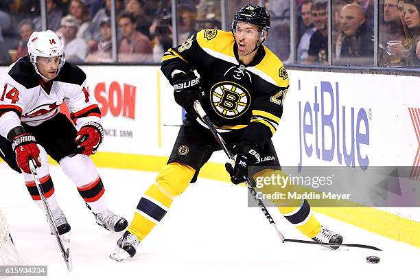 Dominic Moore of the Boston Bruins breaks his stick looking to pass during the first period against New Jersey Devils at TD Garden on October 20,...