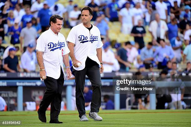 Former Los Angeles Dodgers Steve Garvey and Eric Karros walk to make the ceremonial first pitch before game five of the National League Division...