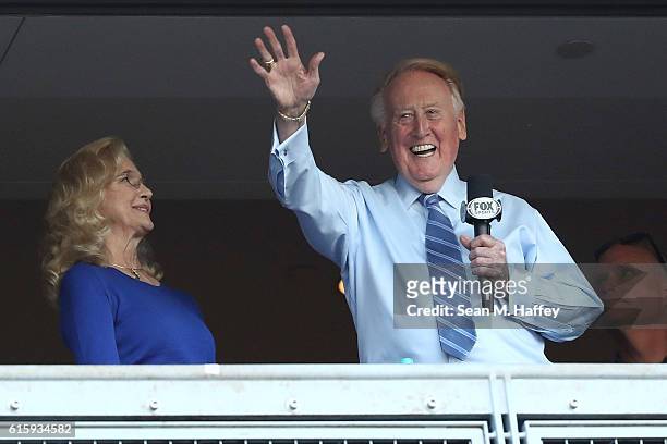 Los Angeles Dodgers broadcaster Vin Scully waves to the crowd alongside his wife Sandra Hunt before the Dodgers take on the Chicago Cubs in game five...