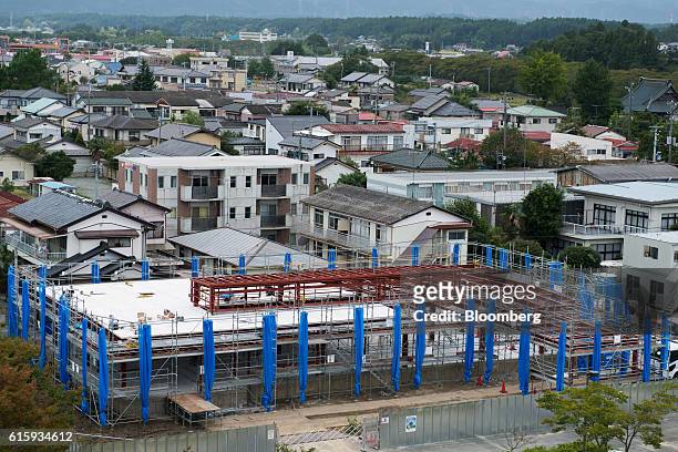 Construction site stands in front of buildings in Namie, Fukushima Prefecture, Japan, on Wednesday, Oct. 5, 2016. Namie, one of the communities...