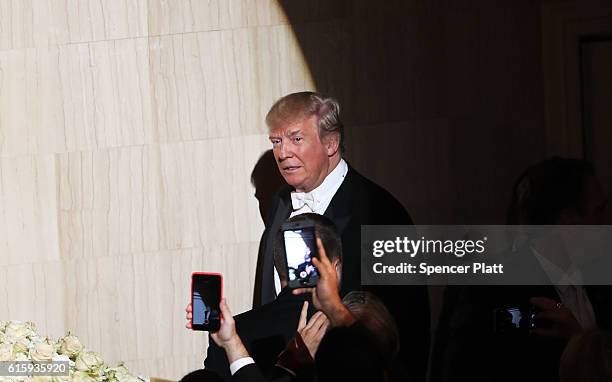 Donald Trump walks onto the stage while attending the annual Alfred E. Smith Memorial Foundation Dinner at the Waldorf Astoria on October 20, 2016 in...