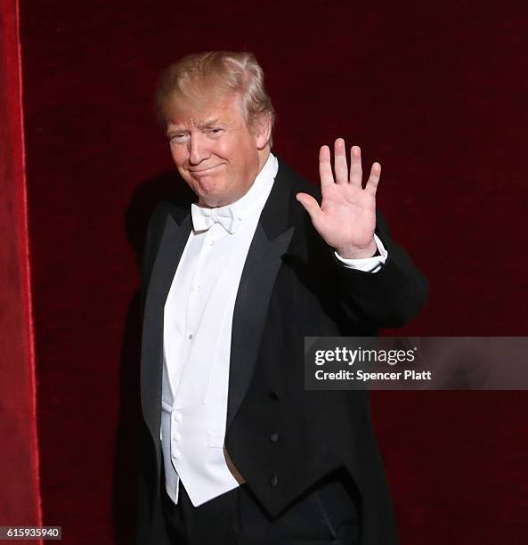 Donald Trump walks onto the stage while attending the annual Alfred E. Smith Memorial Foundation Dinner at the Waldorf Astoria on October 20, 2016 in...