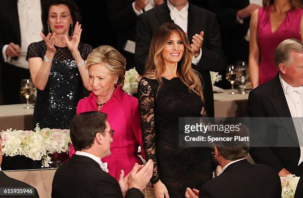 Hillary Clinton walks by Melania Trump while attending the annual Alfred E. Smith Memorial Foundation Dinner at the Waldorf Astoria on October 20,...