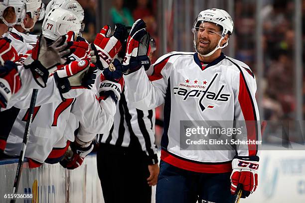 Justin Williams of the Washington Capitals celebrates his first goal of the season with teammate during the first period against the Florida Panthers...