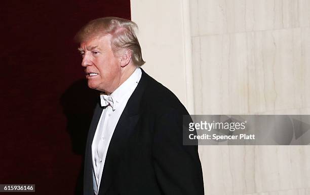 Donald Trump walks onto the stage while attending the annual Alfred E. Smith Memorial Foundation Dinner at the Waldorf Astoria on October 20, 2016 in...