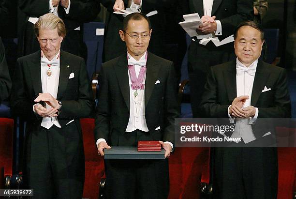 Sweden - Japanese stem cell researcher Shinya Yamanaka , a co-recipient of the 2012 Nobel Prize in medicine, is applauded after receiving his prize...