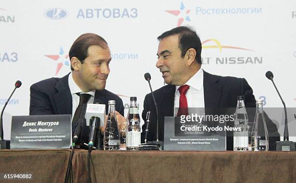 Russia - Russian Industry and Trade Minister Denis Manrurov and Nissan Motor Co. President Carlos Ghosn chat during a signing ceremony in Moscow on...