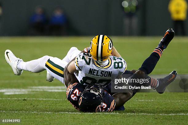Wide receiver Jordy Nelson of the Green Bay Packers is tackled by strong safety Harold Jones-Quartey of the Chicago Bears in the first quarter at...