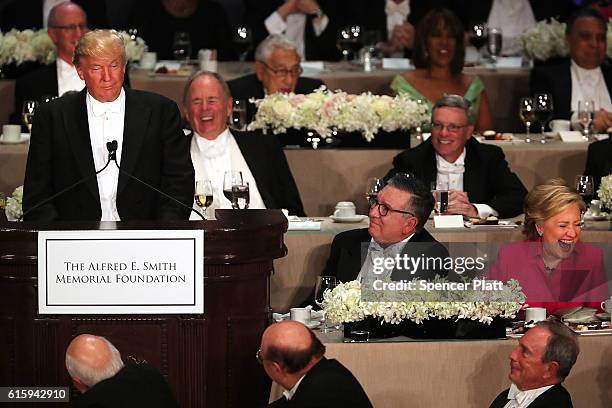 Hillary Clinton laughs as Donald Trump speaks at the annual Alfred E. Smith Memorial Foundation Dinner at the Waldorf Astoria on October 20, 2016 in...